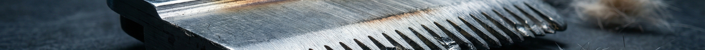 worn clipper blade with hair buildup showing signs it needs replacement grooming